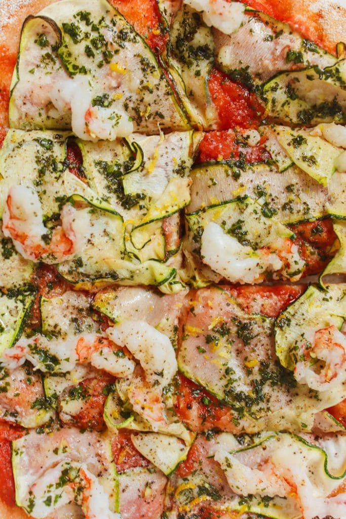 Close-up of a delicious Italian pizza topped with zucchini and cheese, perfect for food photography.